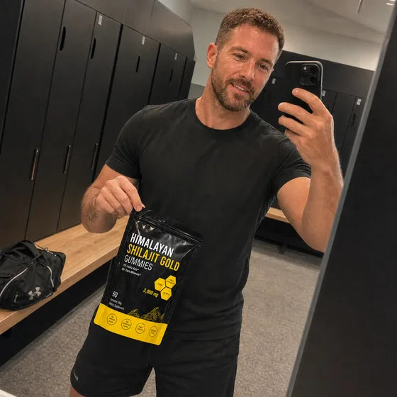 Gym customer holding MENRYX Himalayan Shilajit Gold Gummies