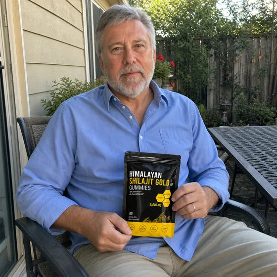 Older customer holding MENRYX Himalayan Shilajit Gold Gummies on a patio